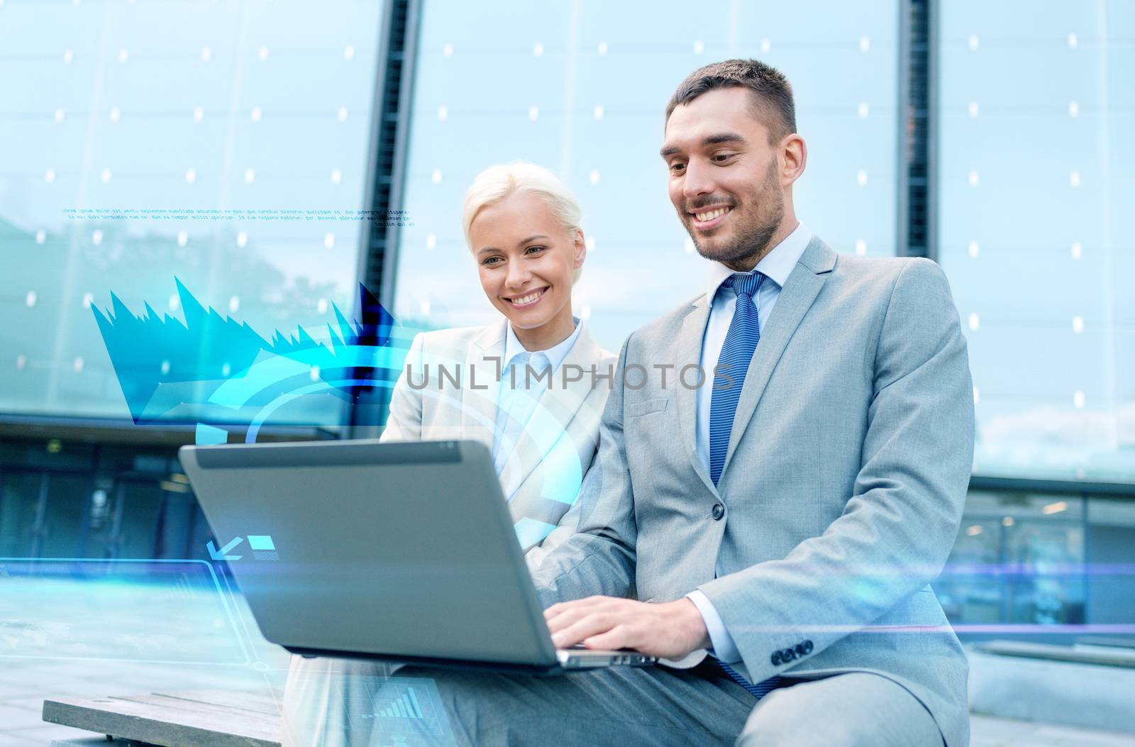 business, technology and people concept - smiling businesspeople working with laptop computer and virtual graph projection on city street