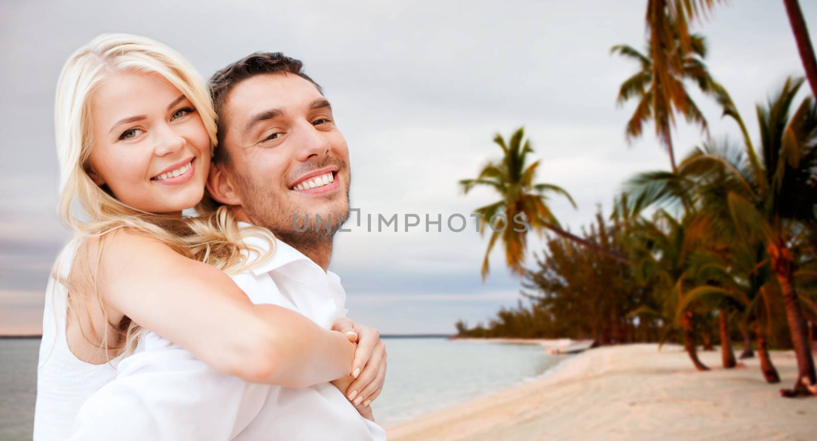 couple having fun and hugging on beach by dolgachov