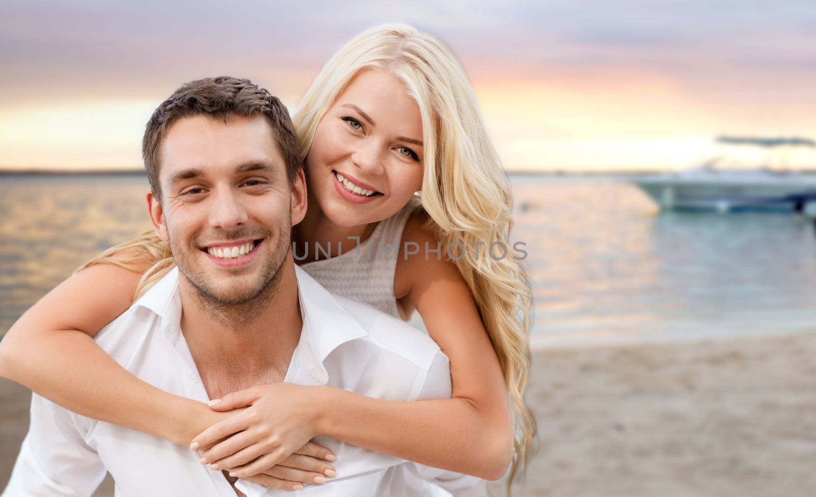 happy couple having fun over beach background by dolgachov