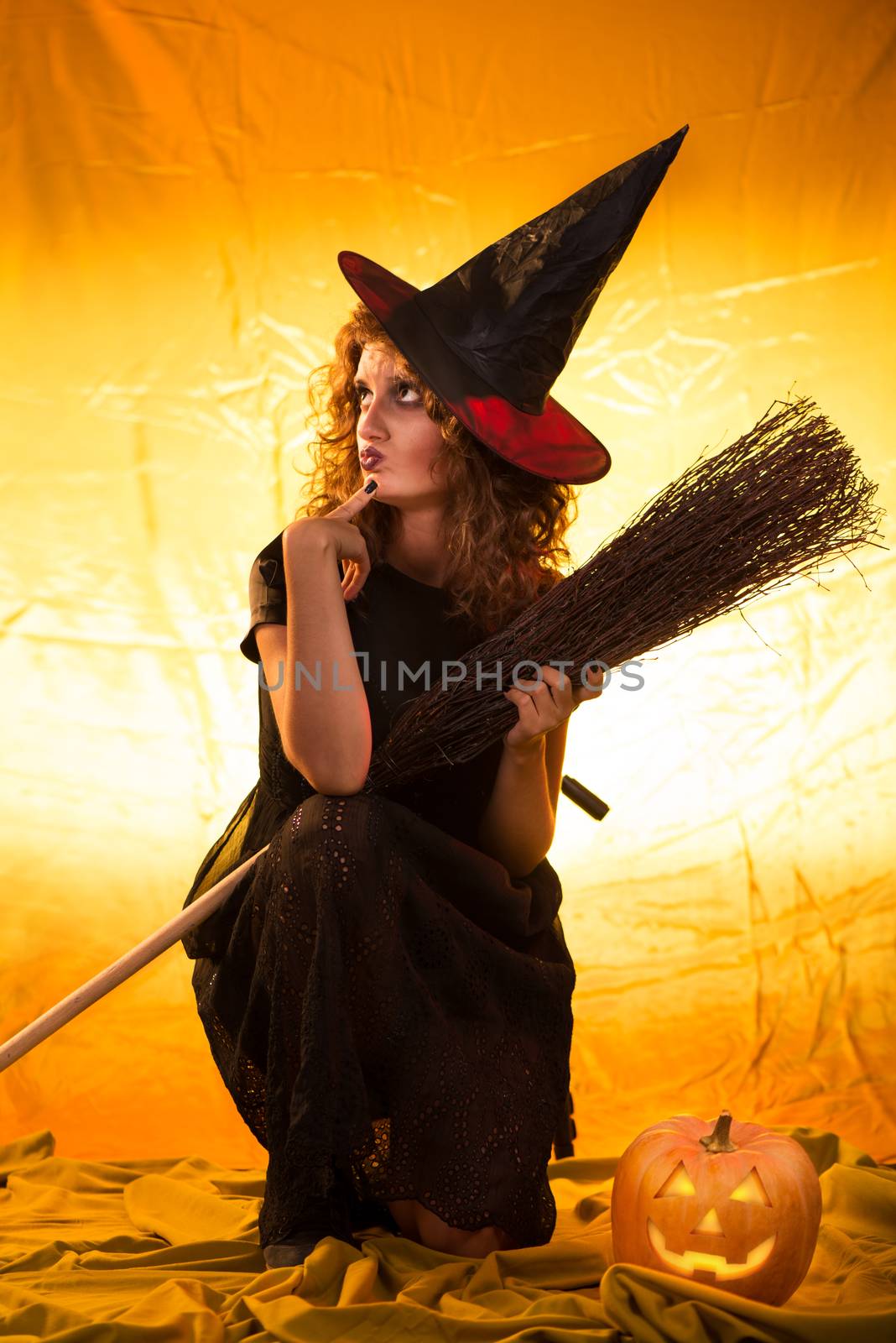 Young woman dressed like a witch and thinking.