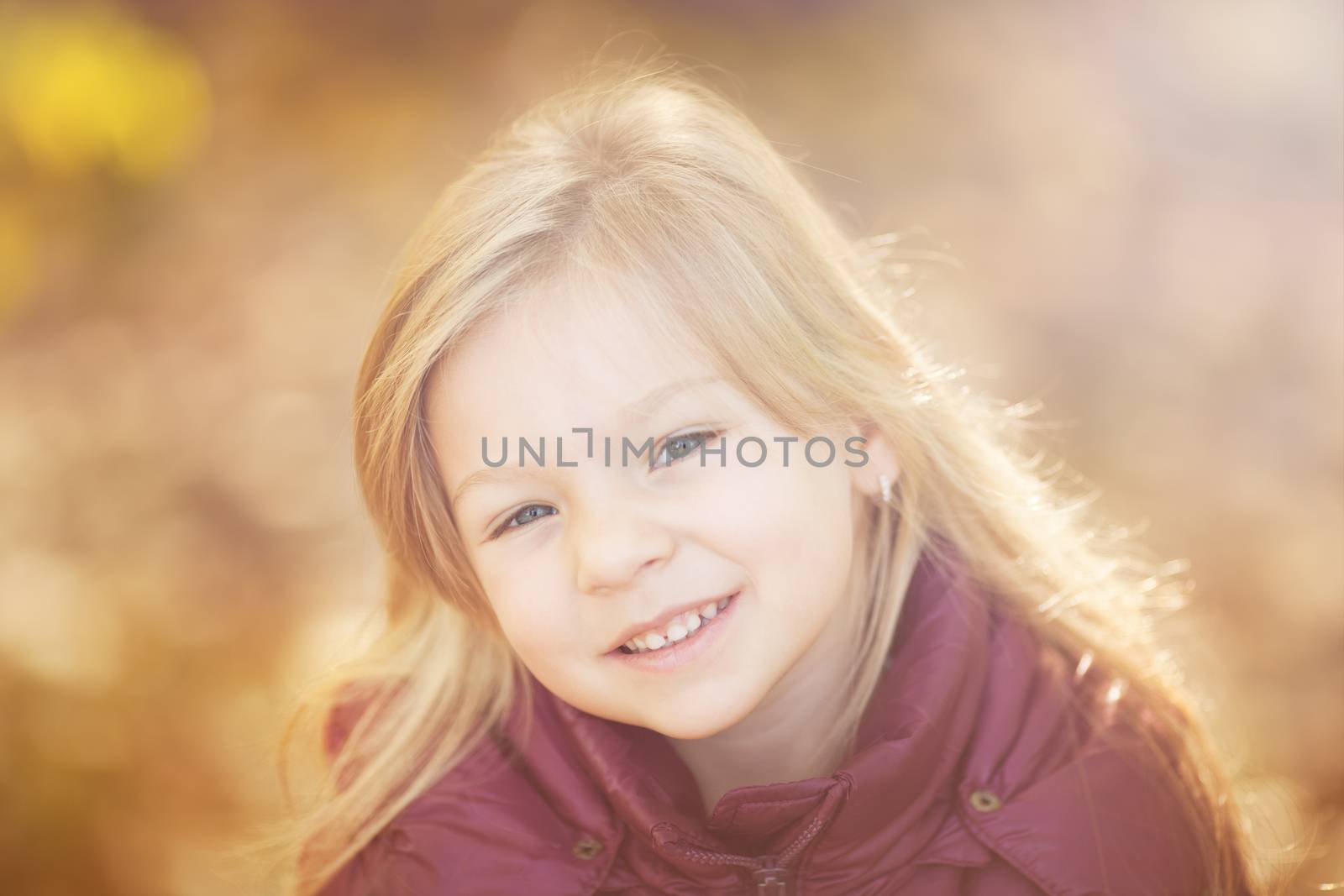 Portrait of cute little girl on beautiful autumn day.