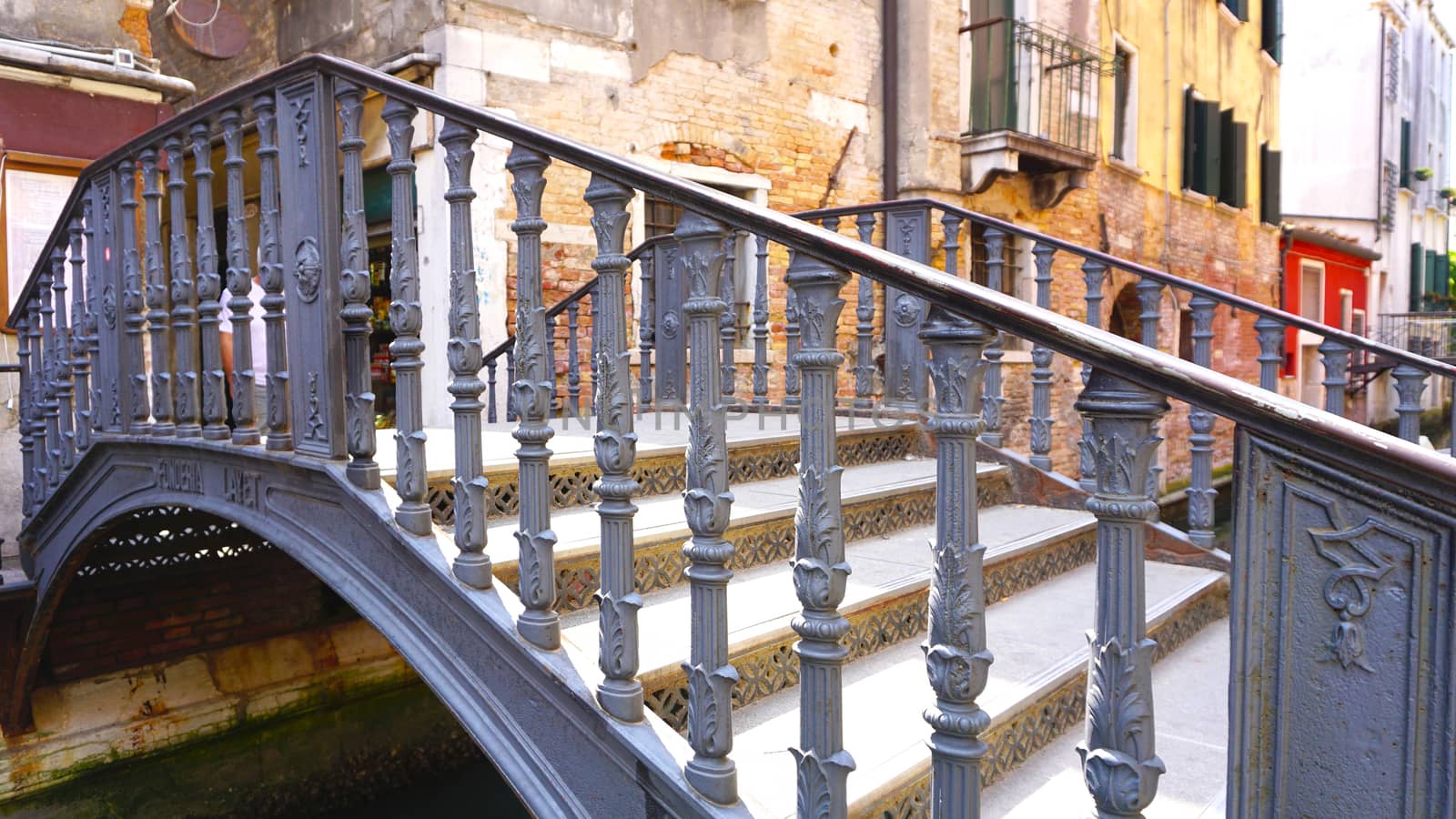 metal bridge cross canal in venice, italy