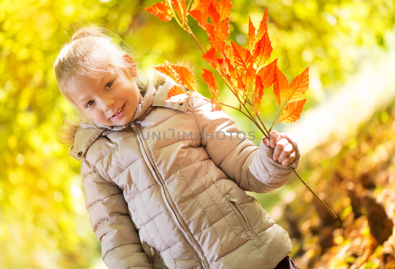 Portrait of cute little girl on beautiful autumn day.