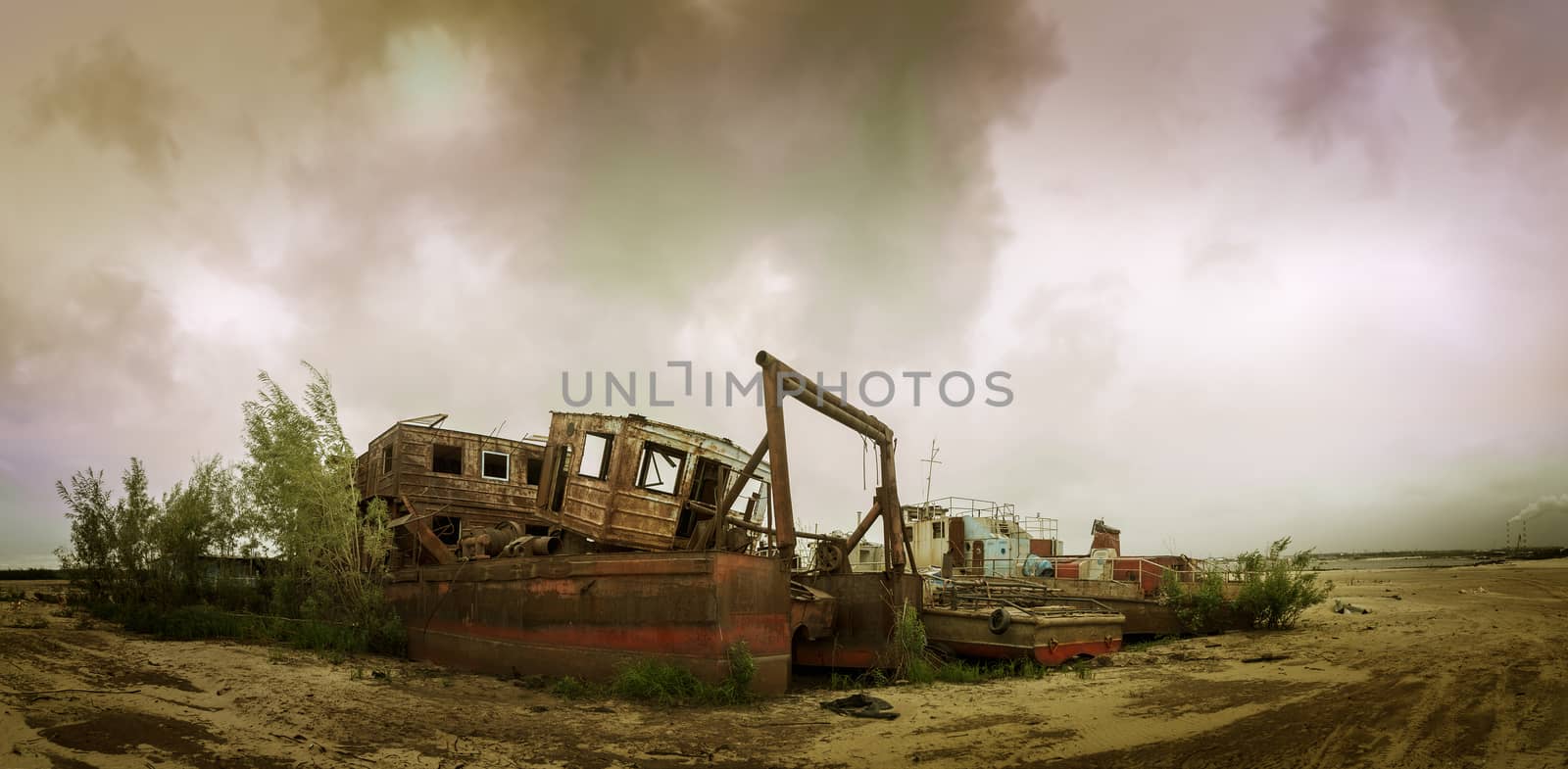 Old wrecked boat on the coast. Autumn sky background.