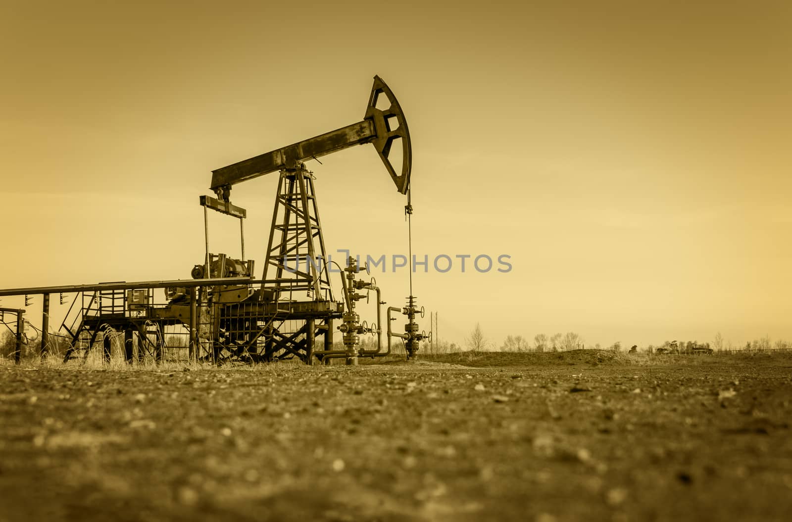 Pump jack and wellheads. Extraction of oil. Toned.