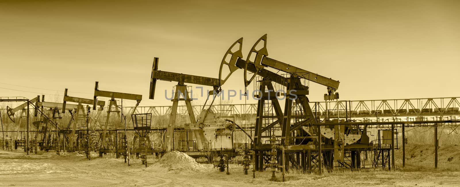 Oil pumps on a oil field. by bashta