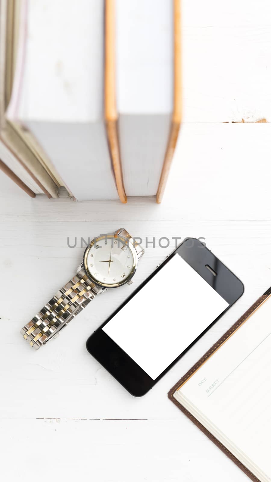 cellphone with stack of book and watch by ammza12