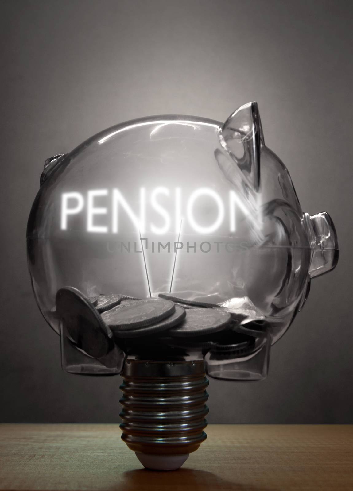 Piggybank light bulb with pension lit text inside and cash