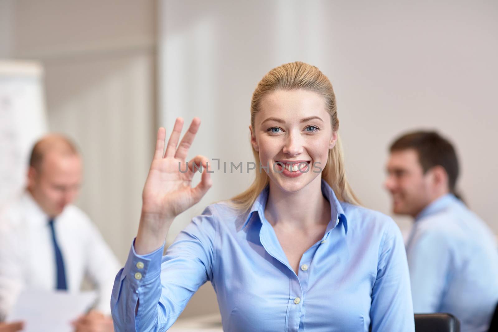 group of smiling businesspeople meeting in office by dolgachov