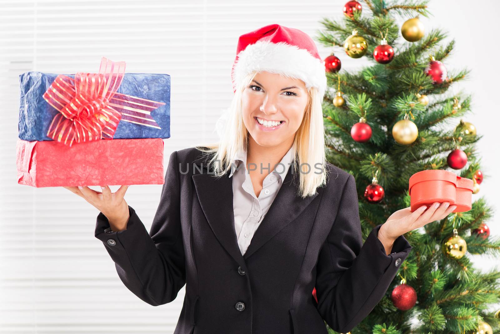 Happy Christmas businesswoman with Santa holding Christmas Presents.