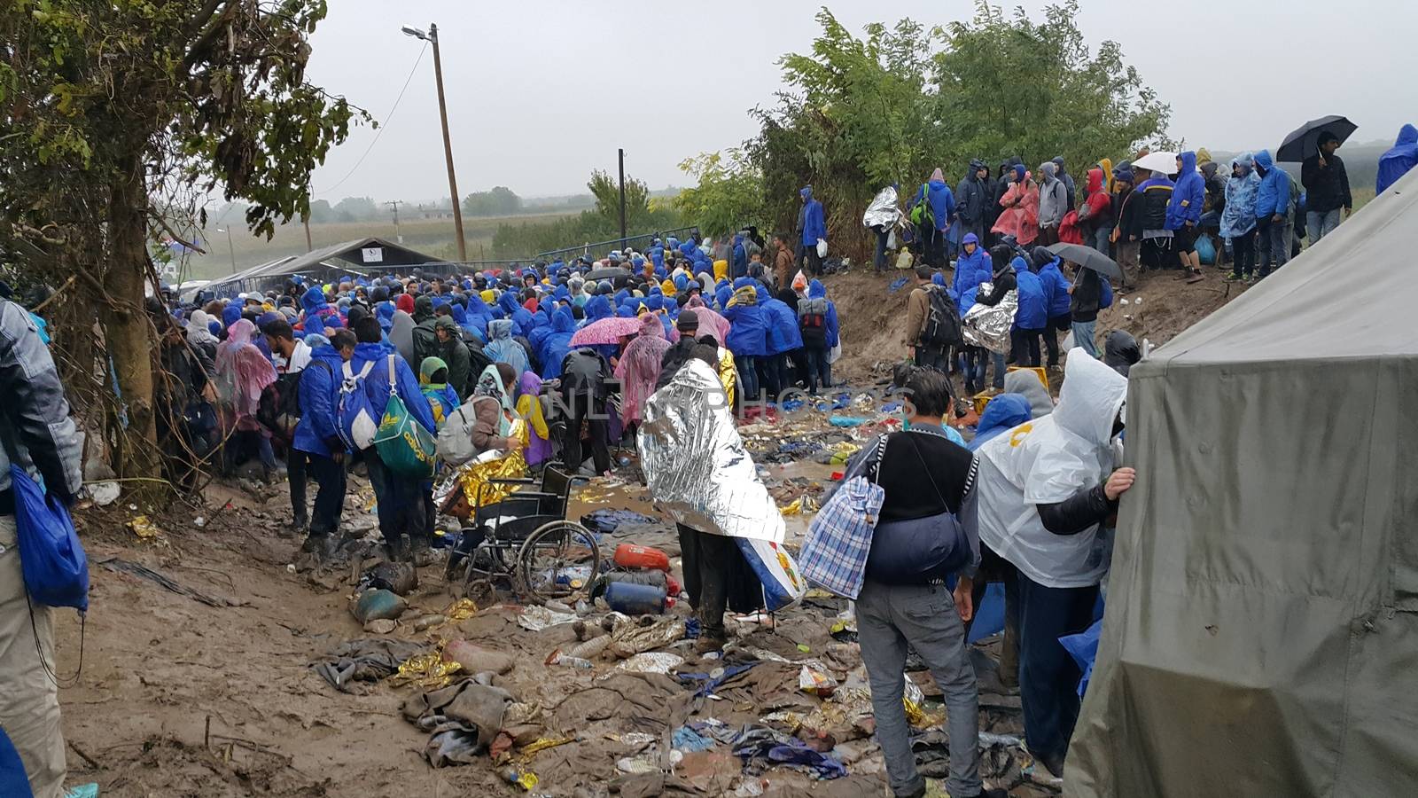 SERBIA, Sid: Refugees gather at a camp in Sid, Serbia on October 19, 2015, where they have been stranded in the cold for nearly two days before the opening of the border with Croatia that day. The area has become increasingly congested with refugees since the weekend, when Hungary closed its borders with Croatia.