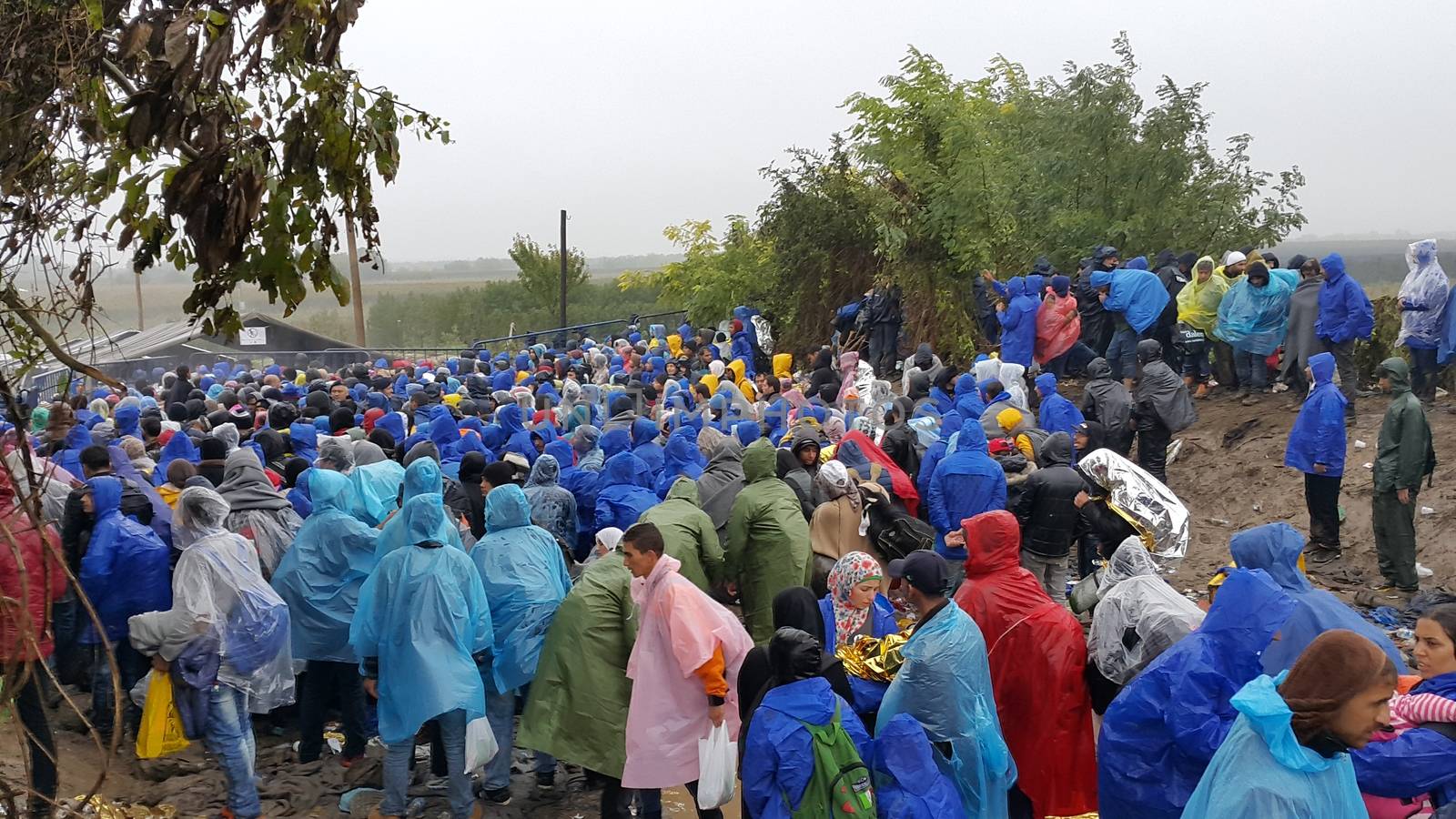 SERBIA, Sid: Refugees gather at a camp in Sid, Serbia on October 19, 2015, where they have been stranded in the cold for nearly two days before the opening of the border with Croatia that day. The area has become increasingly congested with refugees since the weekend, when Hungary closed its borders with Croatia.