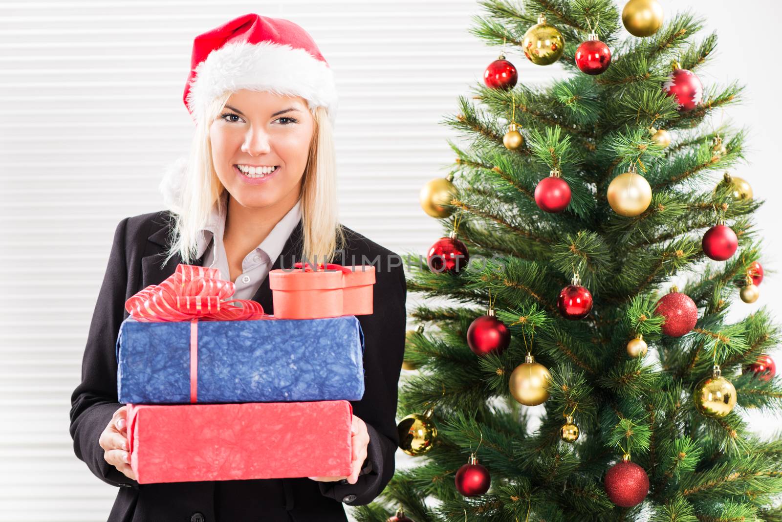 Happy Christmas businesswoman with Santa holding Christmas Presents.