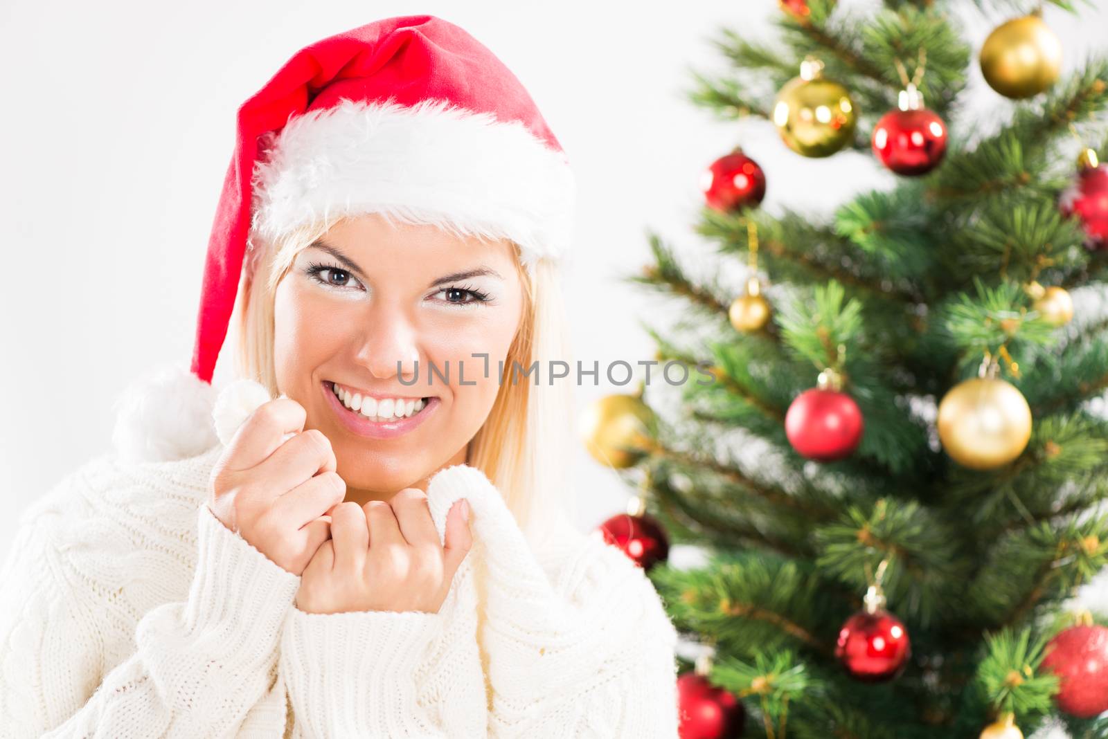 Portrait of beautiful happy christmas girl with Santa Hat.