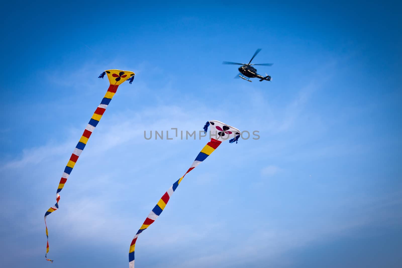 kite flying and helicopter in the background