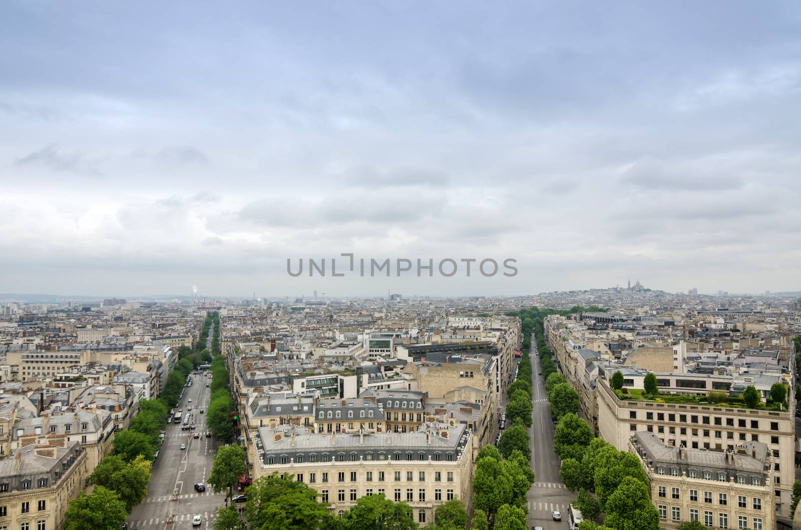 View of the Champs Elysees with montmartre in the background by siraanamwong