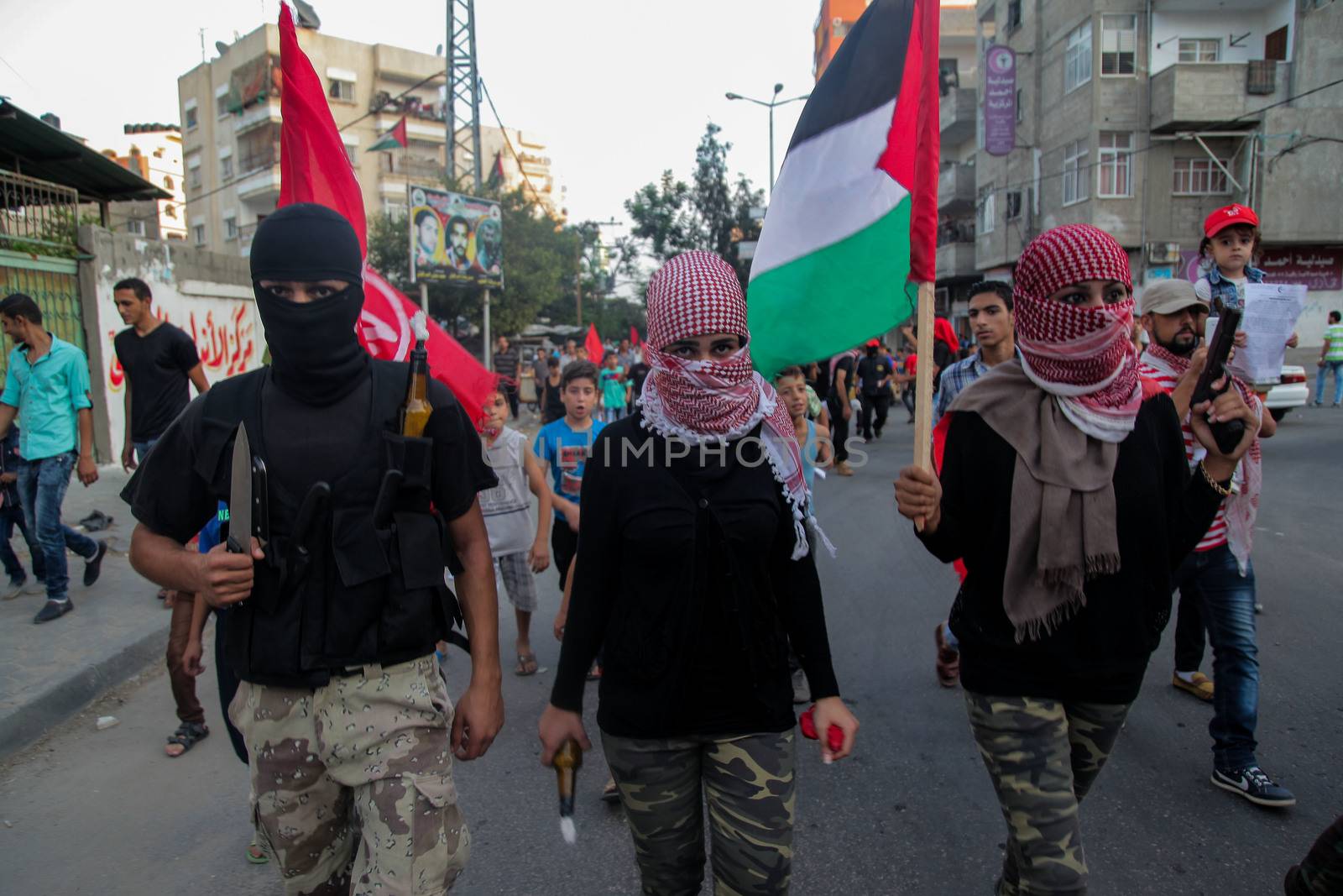 GAZA, Gaza City: Members of the Popular Front for the Liberation of Palestine hold weapons and Palestinian flags while participating in a protest in Gaza on October 20, 2015. The group is rallying against what it perceives to be Israeli aggression in Jerusalem, the occupied West Bank and Gaza region over the past month, during which an upsurge of violence, including stabbing and gun attacks, has led to the deaths of at least 37 Palestinians and seven Israelis.  