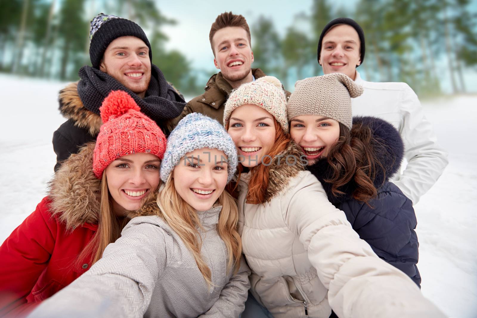 group of smiling friends taking selfie outdoors by dolgachov
