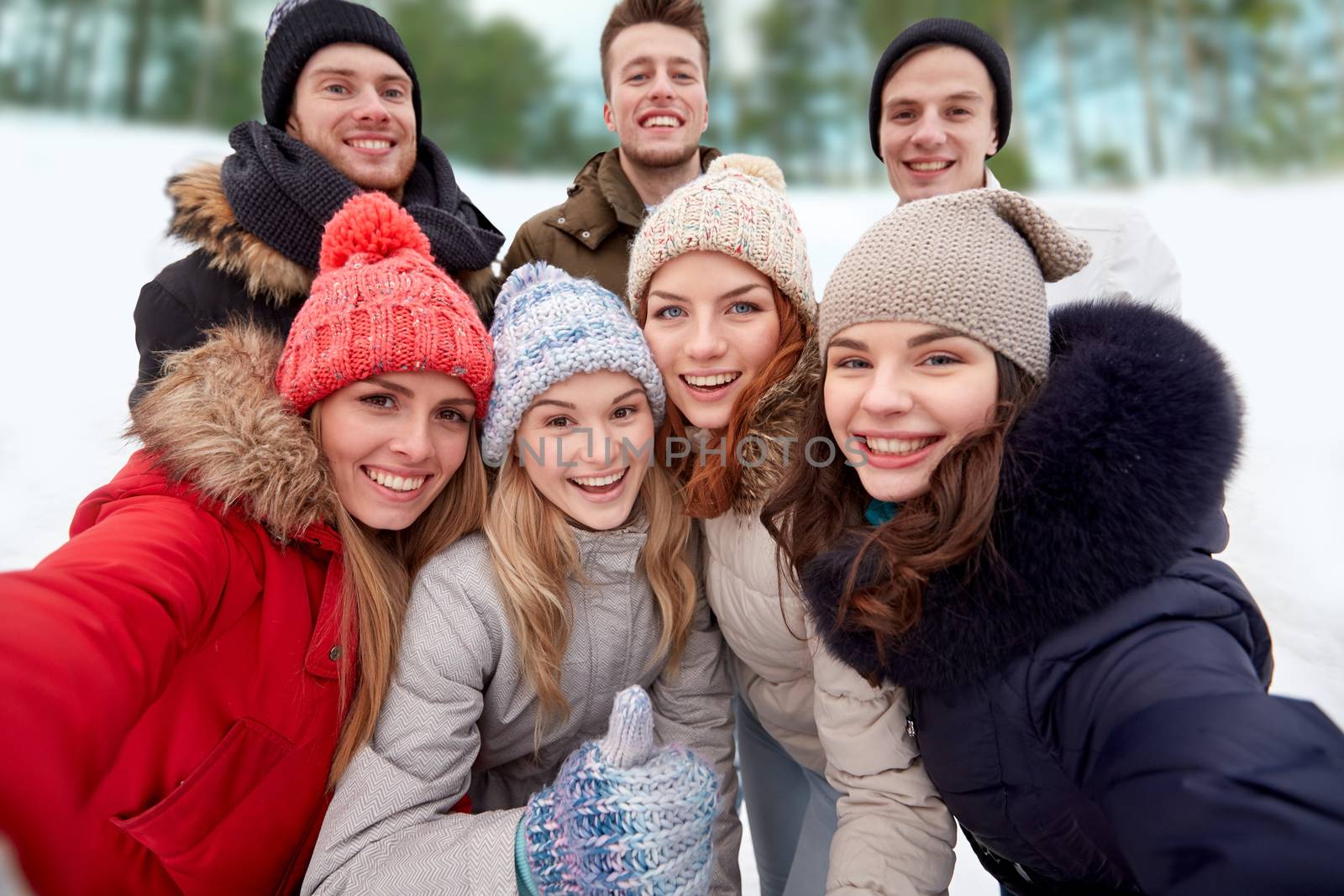 group of smiling friends taking selfie outdoors by dolgachov