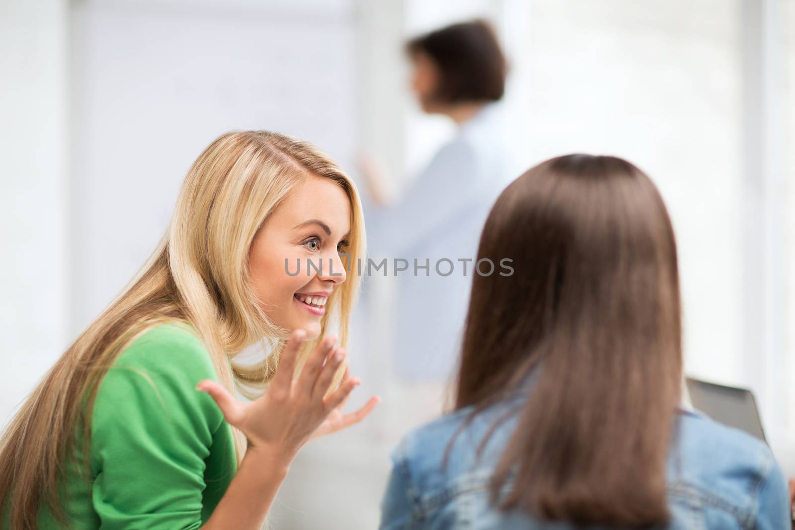 student girl gossiping in lecture at school by dolgachov