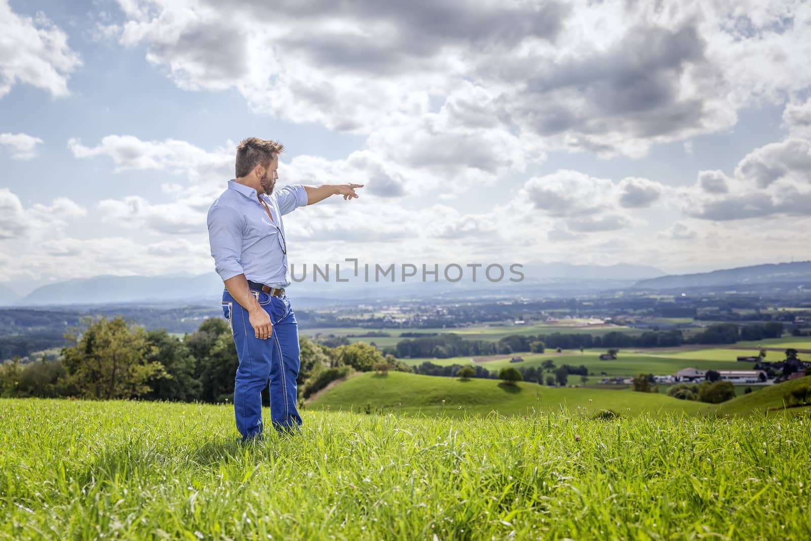 An image of a man outdoors pointing