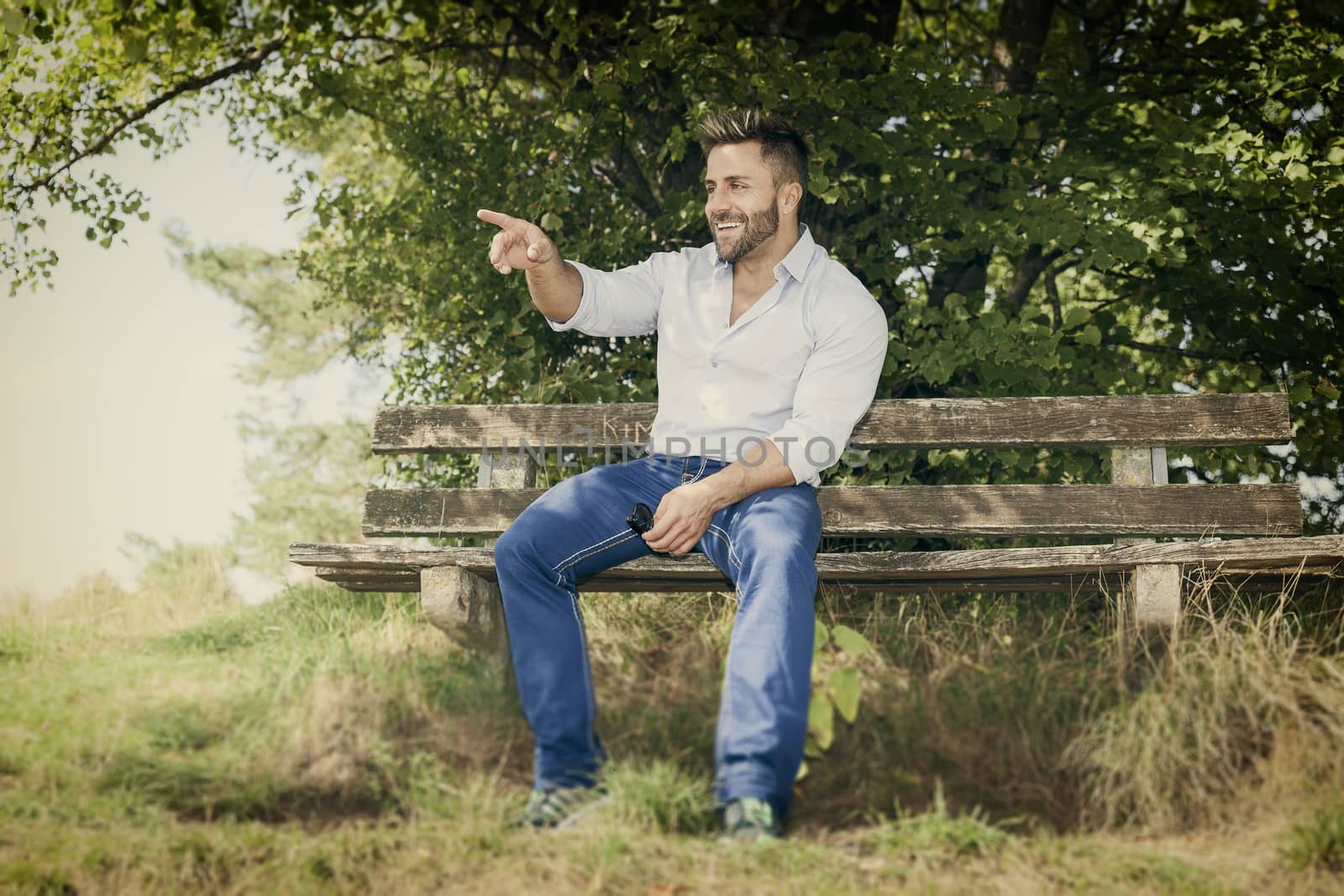 An image of a man outdoors pointing