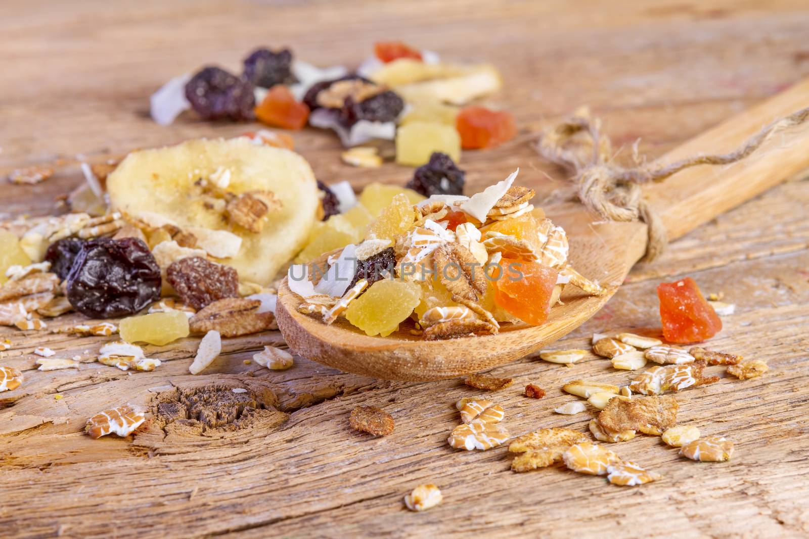 cereals muesli food in wooden spoon on wooden background
