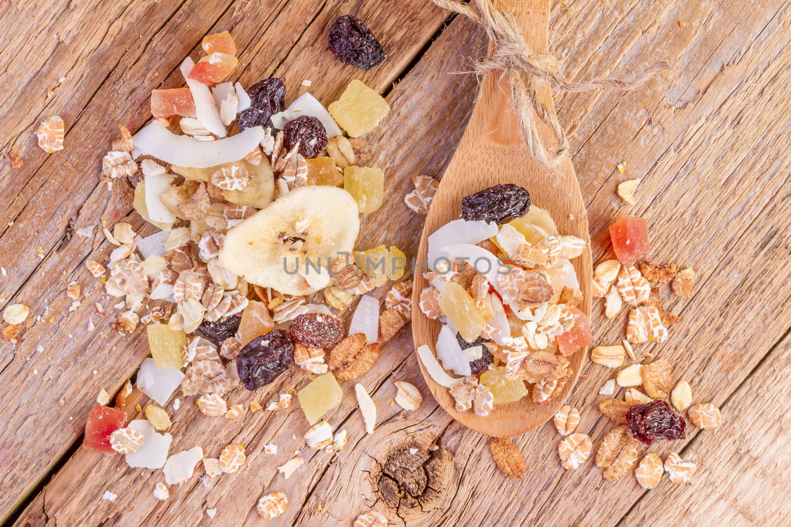 cereals muesli food in wooden spoon on wooden background