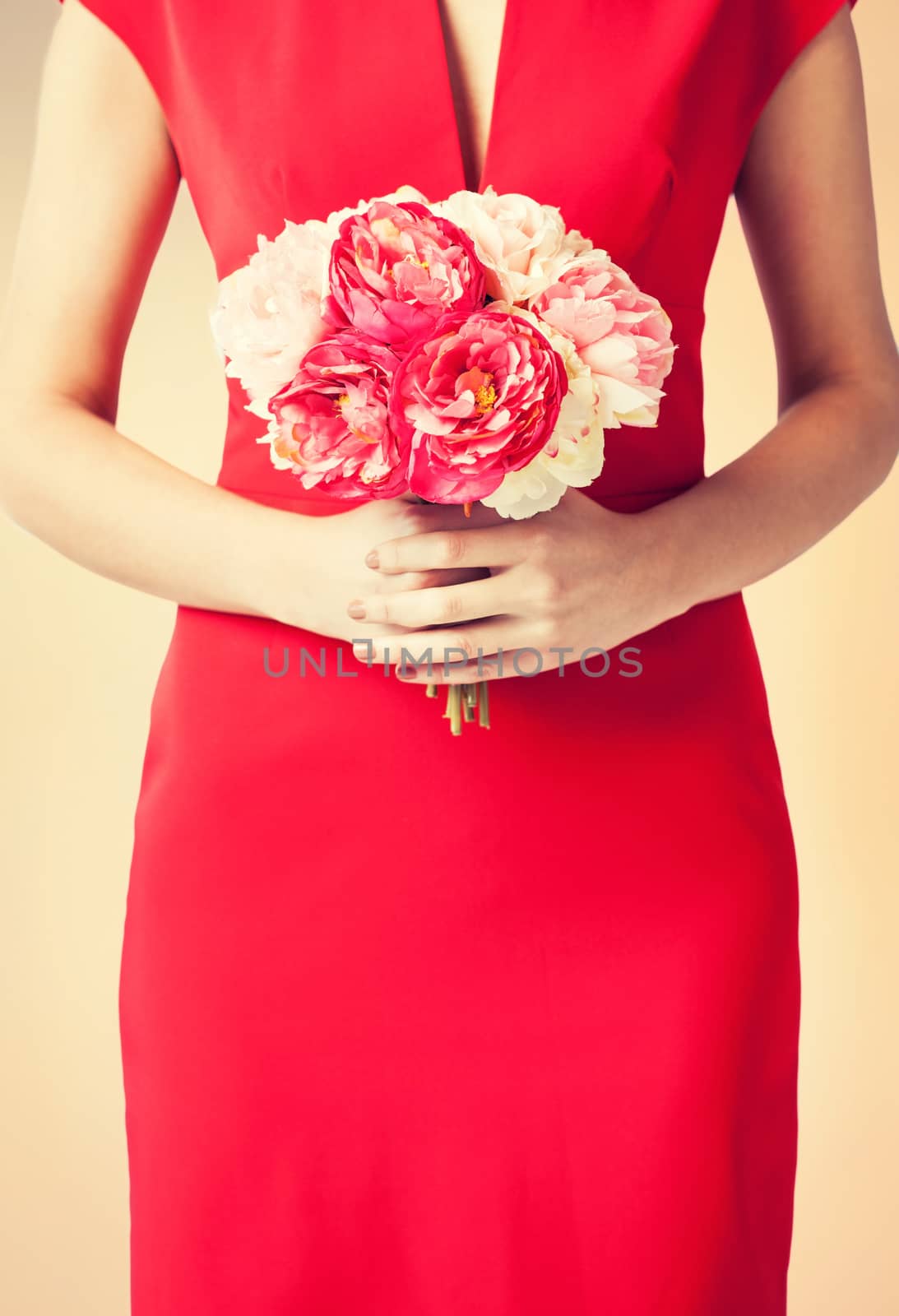 close up of woman hands with bouquet of flowers