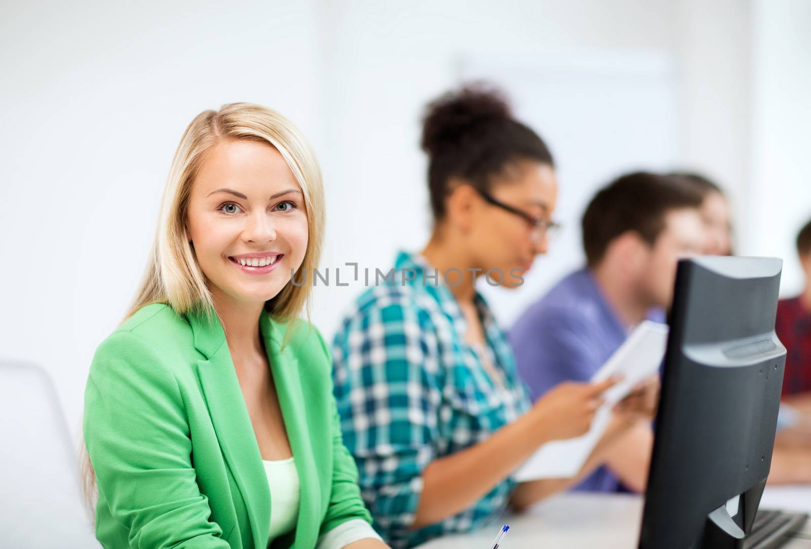 student with computer studying at school by dolgachov