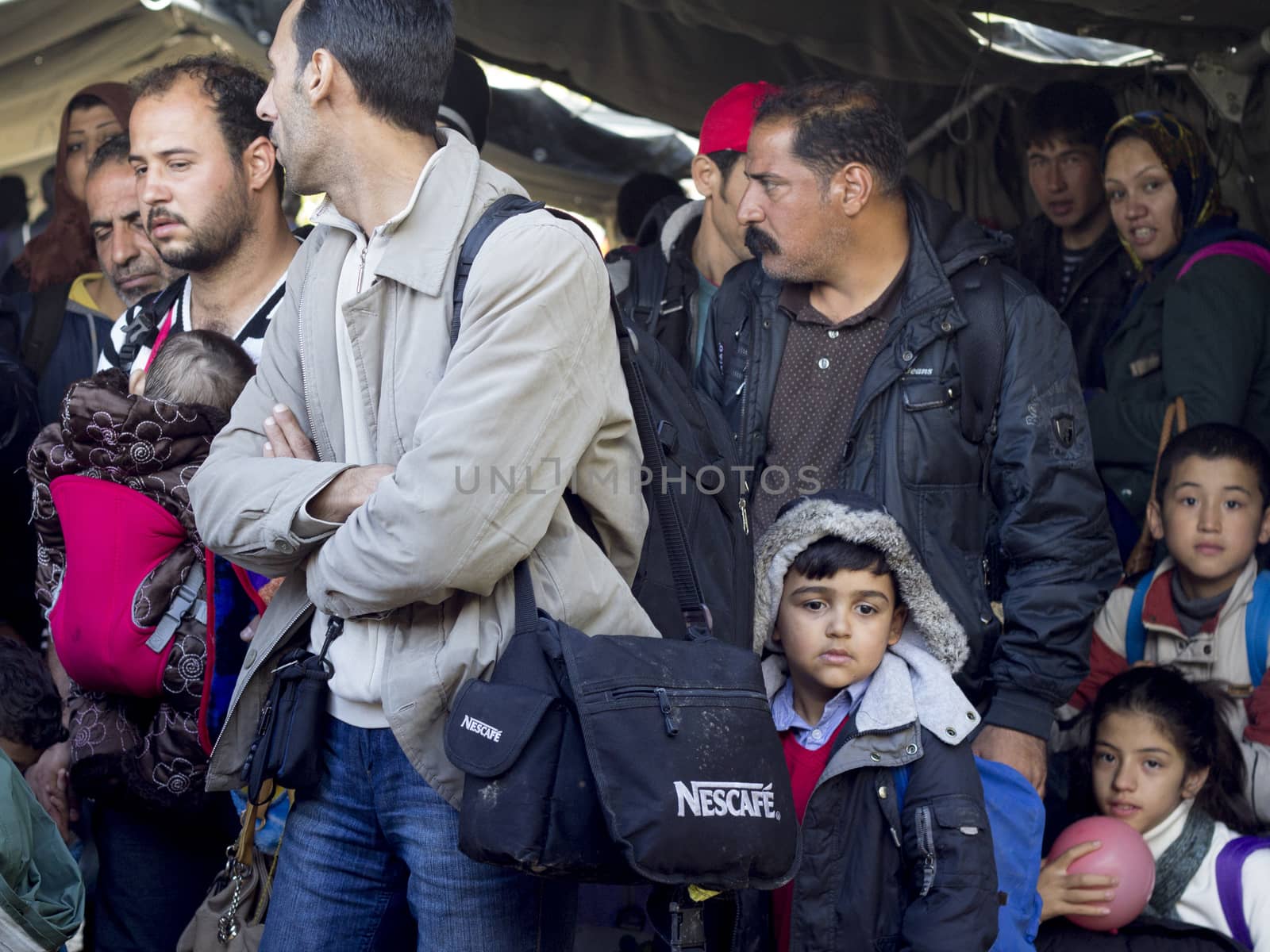 SERBIA, Berkasovo: Families of refugees are pictured in Berkasovo, Serbia, at the border with Croatia, waiting for passing to Bapska, Croatia, on October 17, 2015. In the following days, Austrian, Slovenian and Croatian authorities decided to limit the refugees' passage, causing a 	bottleneck in Berkasovo.