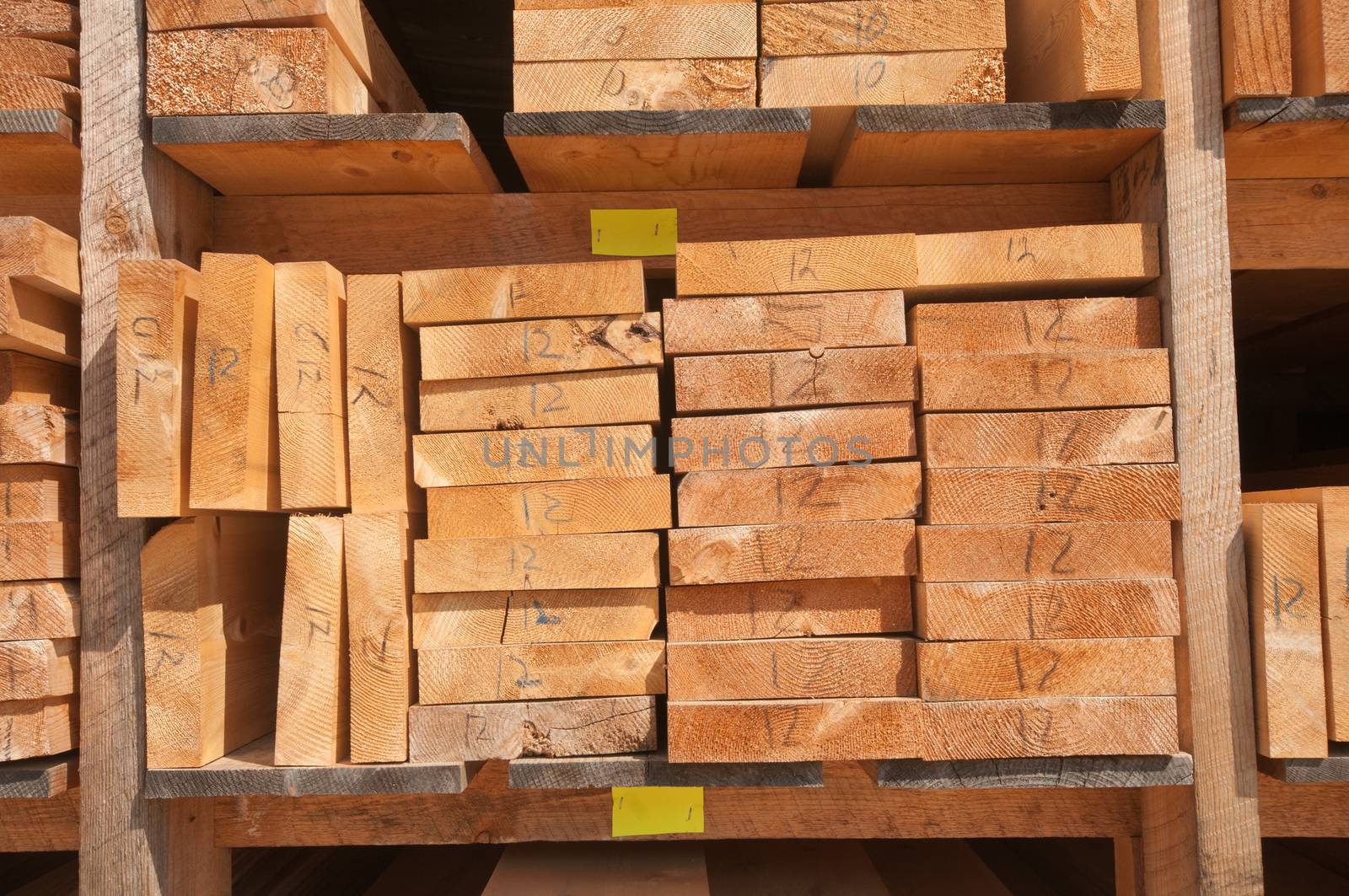 Numbered wood planks stacked at lumber mill in Ontario, Canada