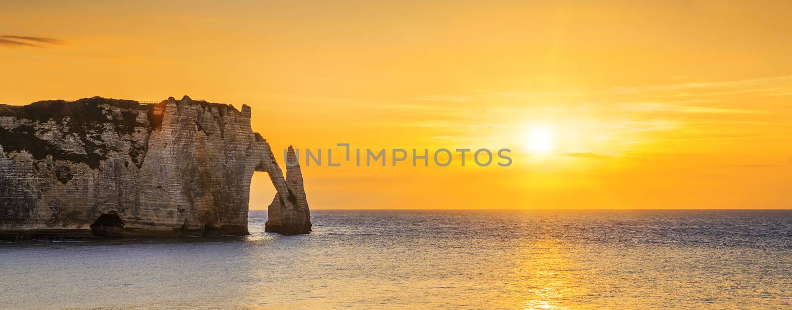Panoramic view of Etretat Aval cliff at sunset
