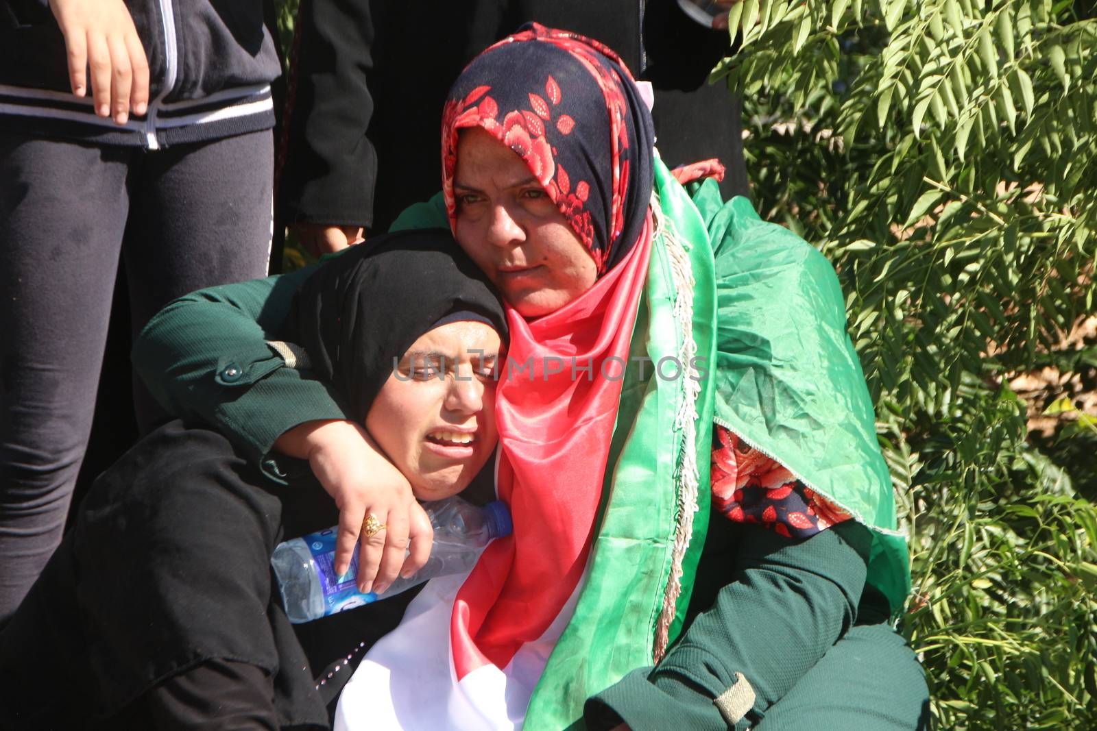 PALESTINE, Hebron: Violence continued in Hebron, Palestine on October 21, 2015 as Palestinians' held a funeral service for a fallen man. Women mourn over the grave of the man who was killed.Hebron was the latest scene of violence as an IDF soldier was stabbed by an attacker on Tuesday. The attacker was shot and killed after the stabbing. 