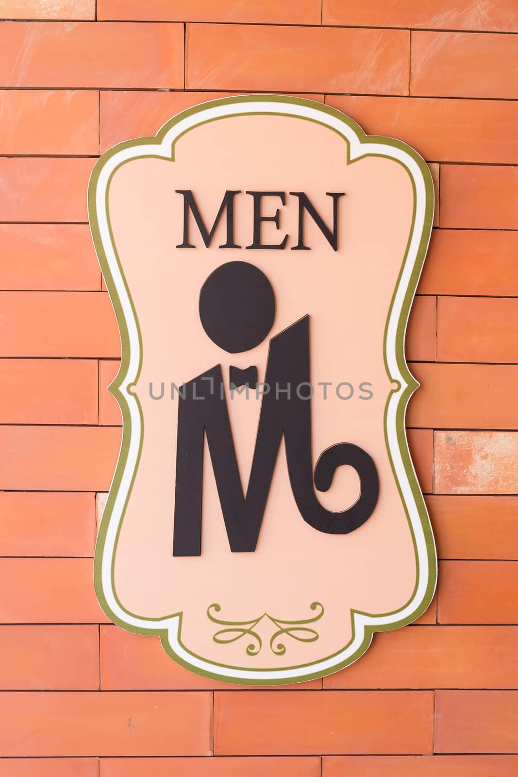 Modern sign on the brick wall of toilet. Text "men" by powerbeephoto