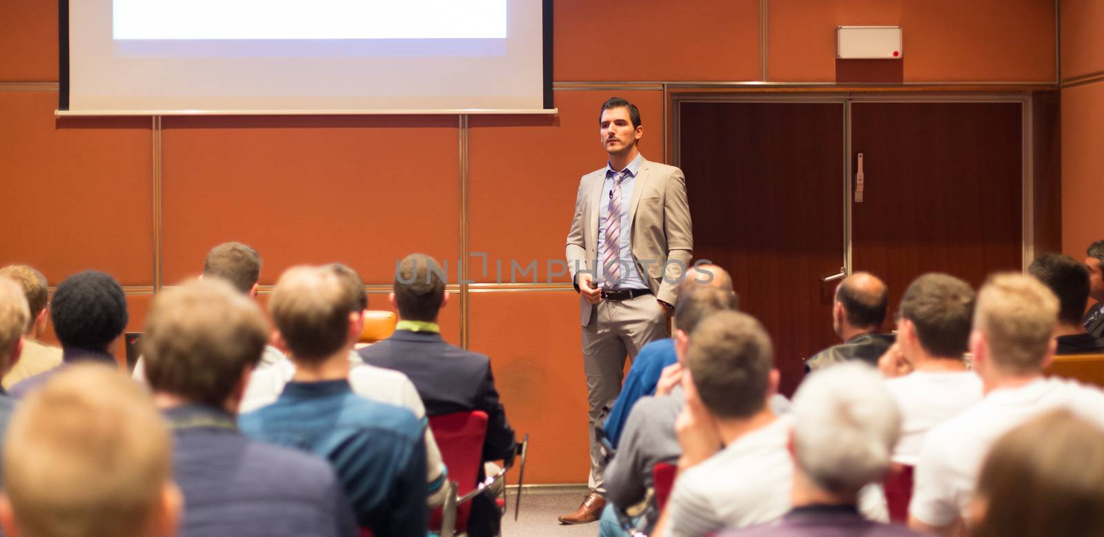 Speaker Giving a Talk at Business Meeting. Audience in the conference hall. Business and Entrepreneurship concept.