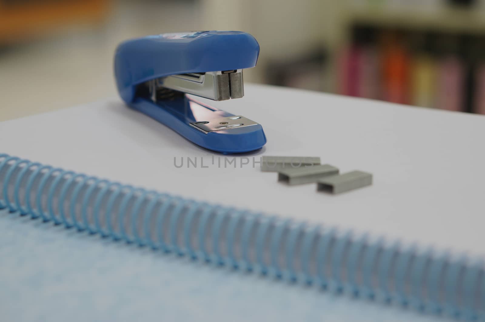 Stapler and staples, stationary suppplies placed on table at office.                             