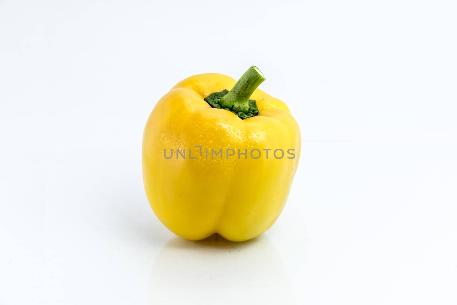 yellow pepper isolated on white background by teerawit