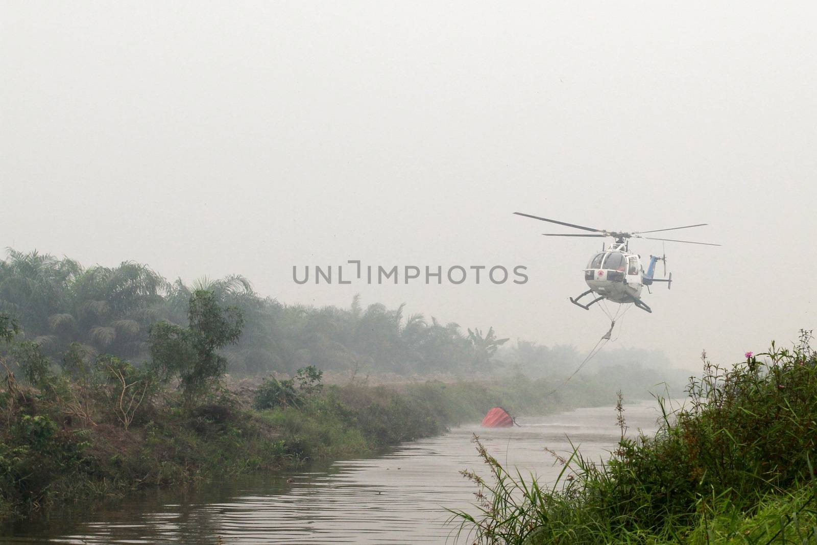  INDONESIA, Kubu Raya: Thick smoke rises up from the fire spot at Kubu Raya district, in West Kalimantan province, on October 21, 2015. Indonesia launched its biggest operation ever to combat fires blanketing Southeast Asia in haze, an official said, with dozens of planes and thousands of troops battling the widespread blazes. 	