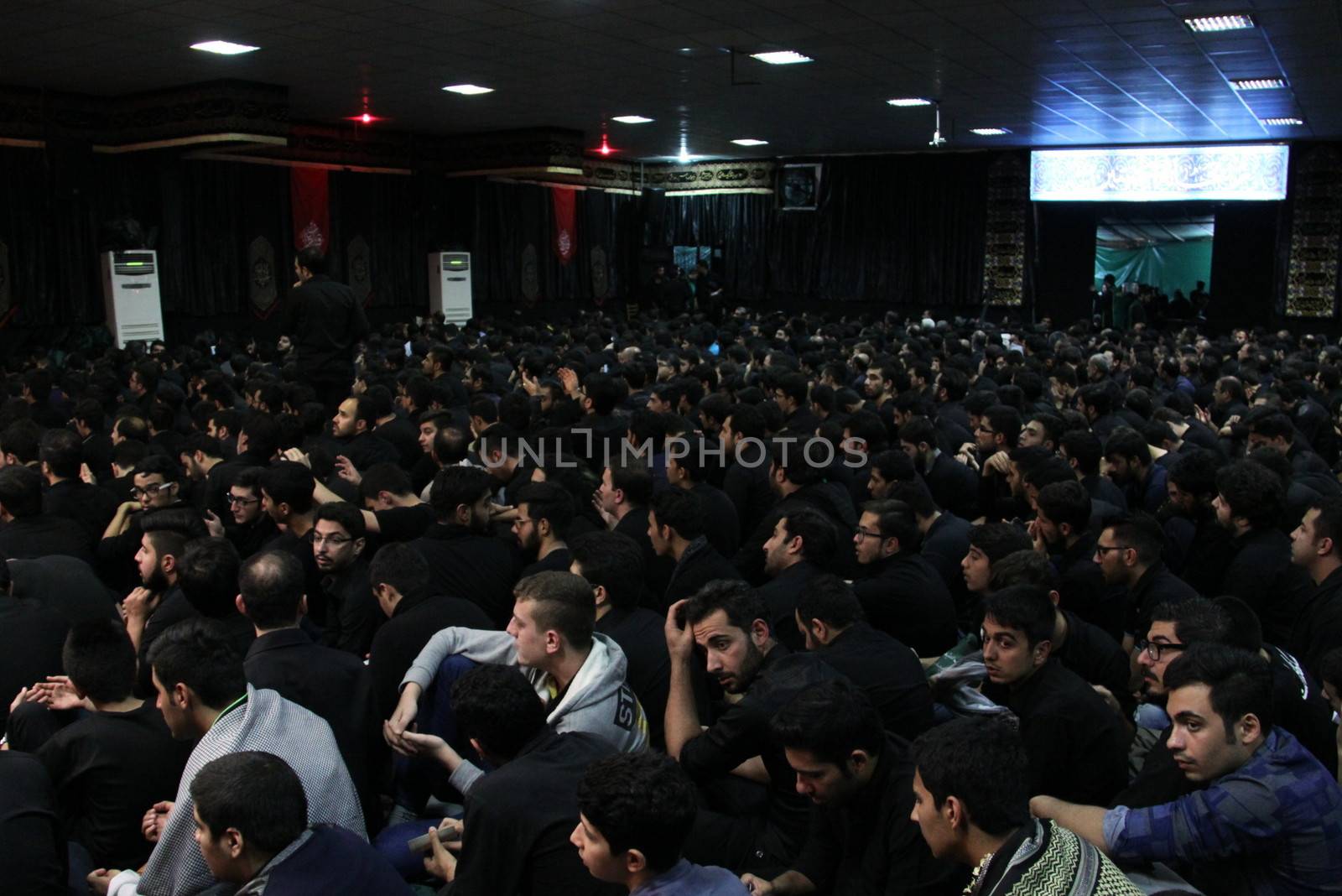 IRAN, Tehran : Hundreds of Shia Muslims gather in Reyhane-Al-Hossein complex building for mourning session in tribute to imam Husayn ibn Ali on October 21, 2015, the 8th night of Muharram. one of the holy months in the Islamic calendar in Tehran, Iran. 