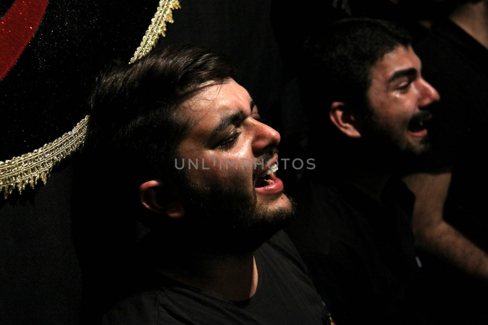 IRAN, Tehran : A man cries during a religion celebration while hundreds of Shia Muslims gather in Reyhane-Al-Hossein complex building for mourning session in tribute to imam Husayn ibn Ali on October 21, 2015, the 8th night of Muharram. one of the holy months in the Islamic calendar in Tehran, Iran. 