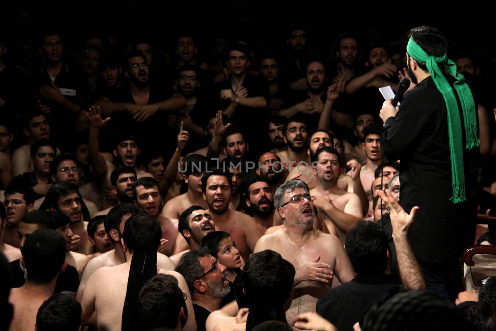 IRAN, Tehran : Hundreds of shirtless Shia Muslims gather in Reyhane-Al-Hossein complex building for mourning session in tribute to imam Husayn ibn Ali on October 21, 2015, the 8th night of Muharram. one of the holy months in the Islamic calendar in Tehran, Iran. 