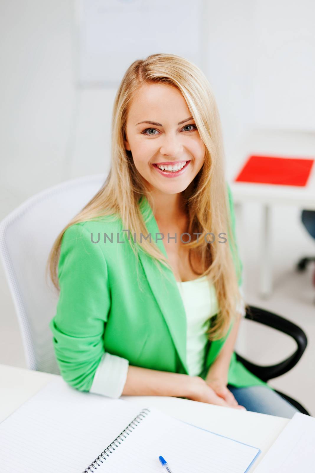 education concept - smiling student girl studying in college