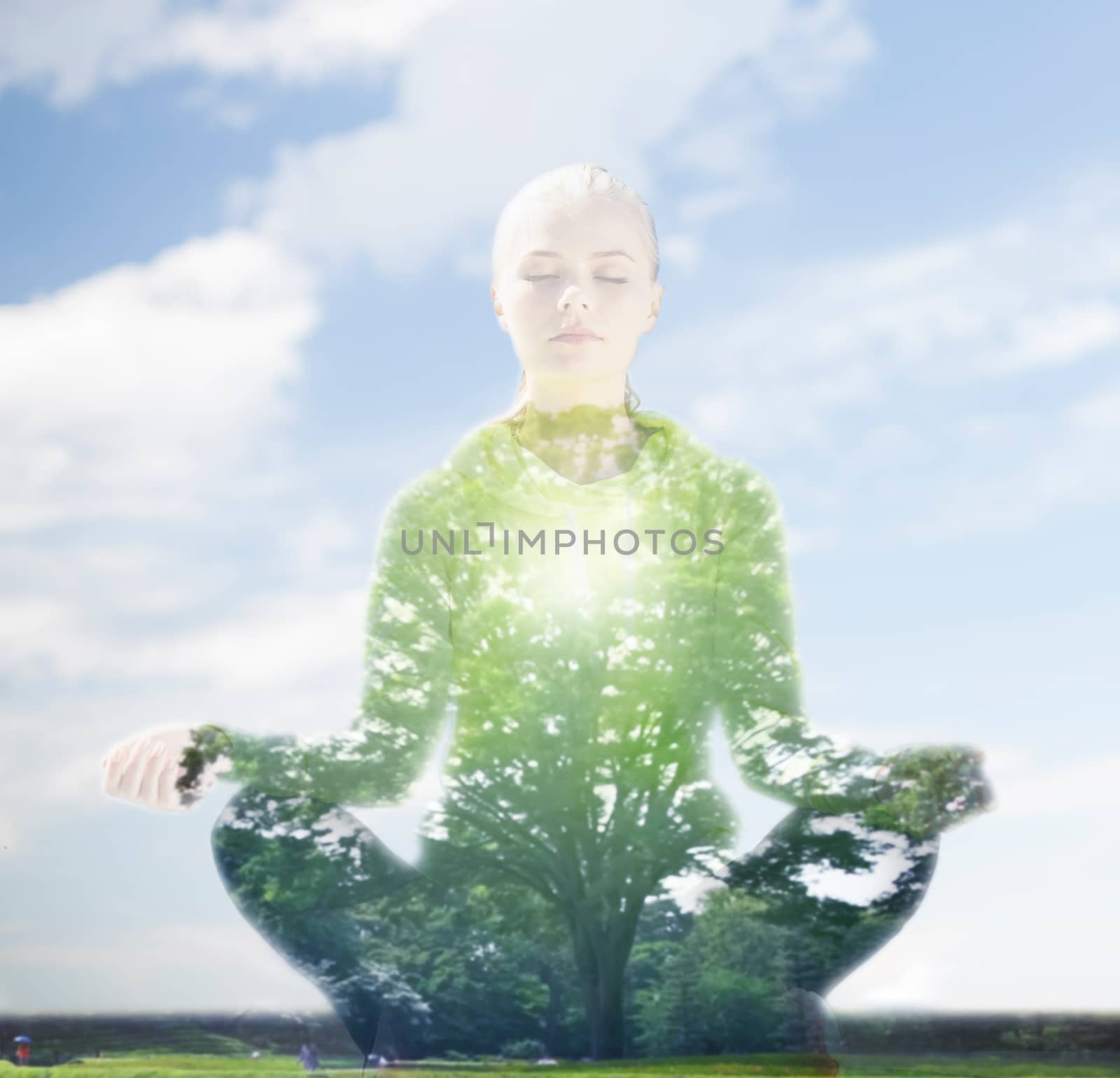 happy young woman doing yoga outdoors by dolgachov