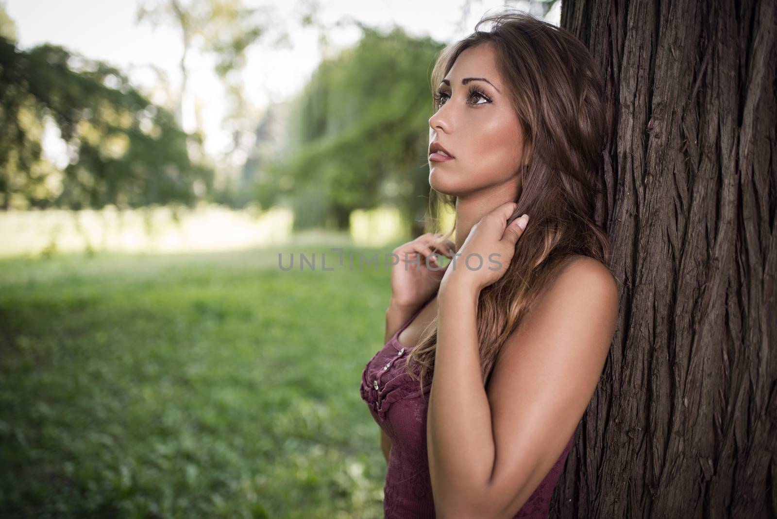 Portrait of a beautiful thinking girl in the nature.