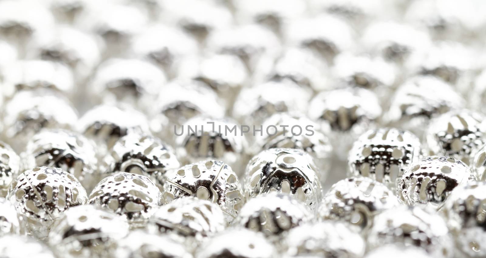 Beautiful metal beads closeup on white background