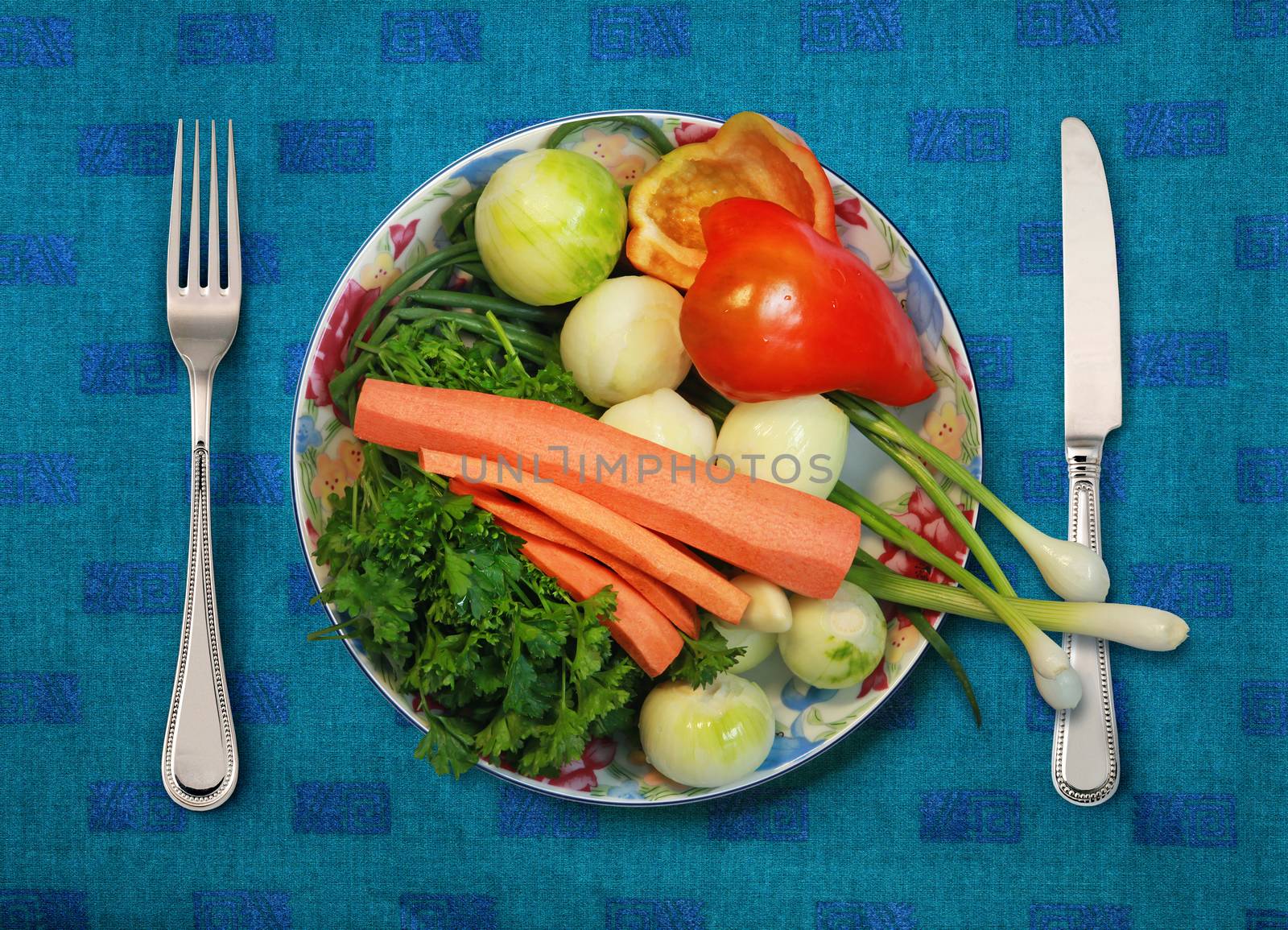 vegetables on white plate, knife and fork