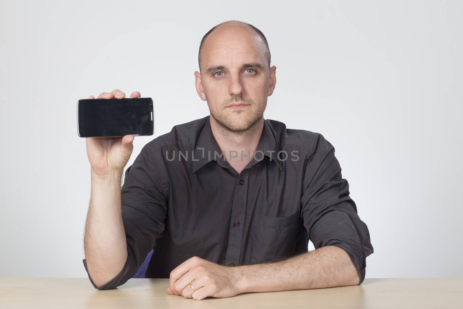 Man holds up phone to show screen