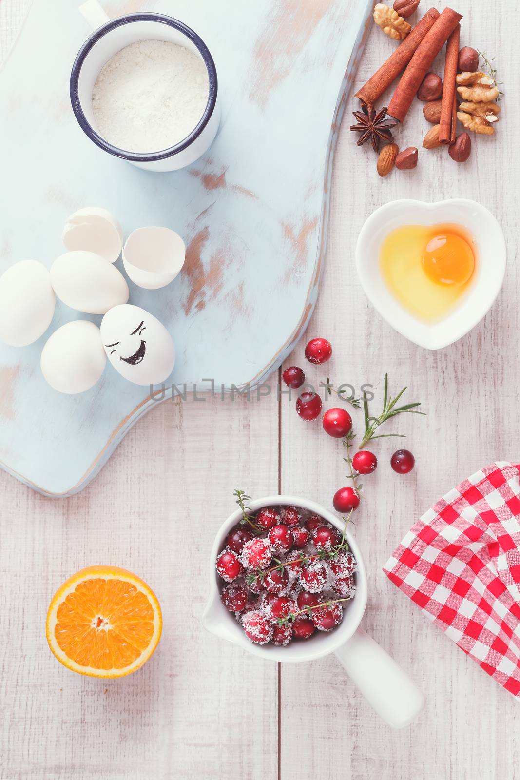 Ingredients for cranberry and orange cake on wooden table, vintage style, top view. Natural light