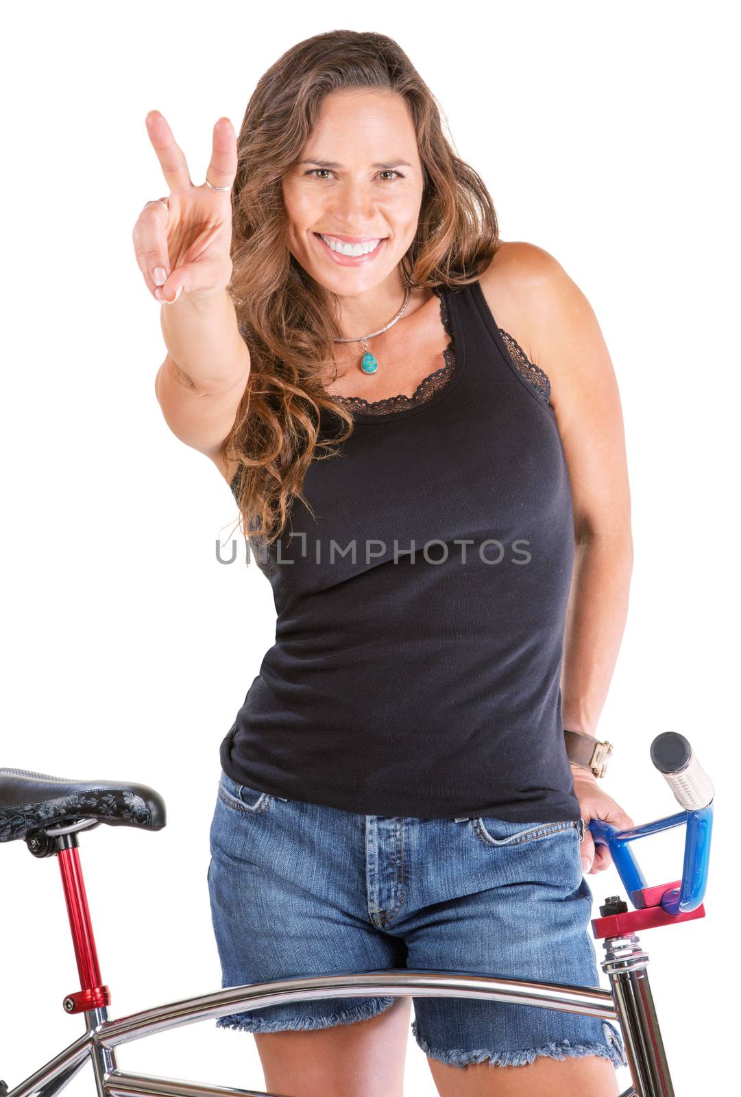 Isolated cute woman gesturing victor symbol with her bike